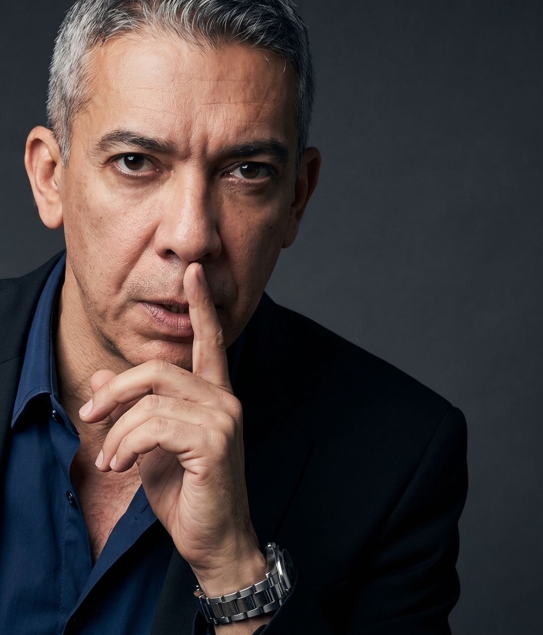 Dr. Diaa Al-Awadi with a finger to his lips