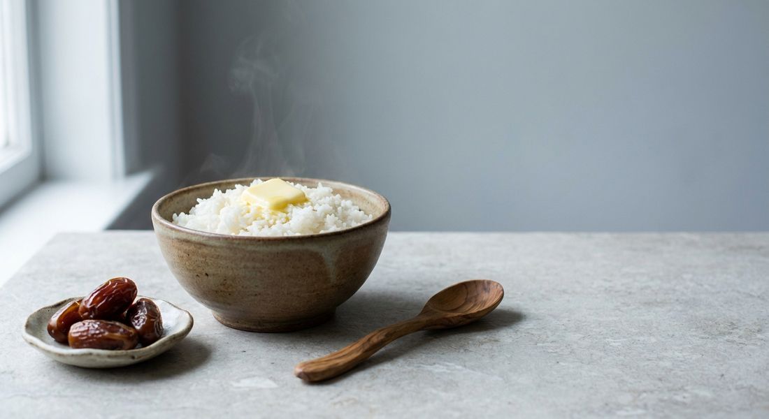 A bowl of white rice with butter and dates, allowed on the Tayyibat diet